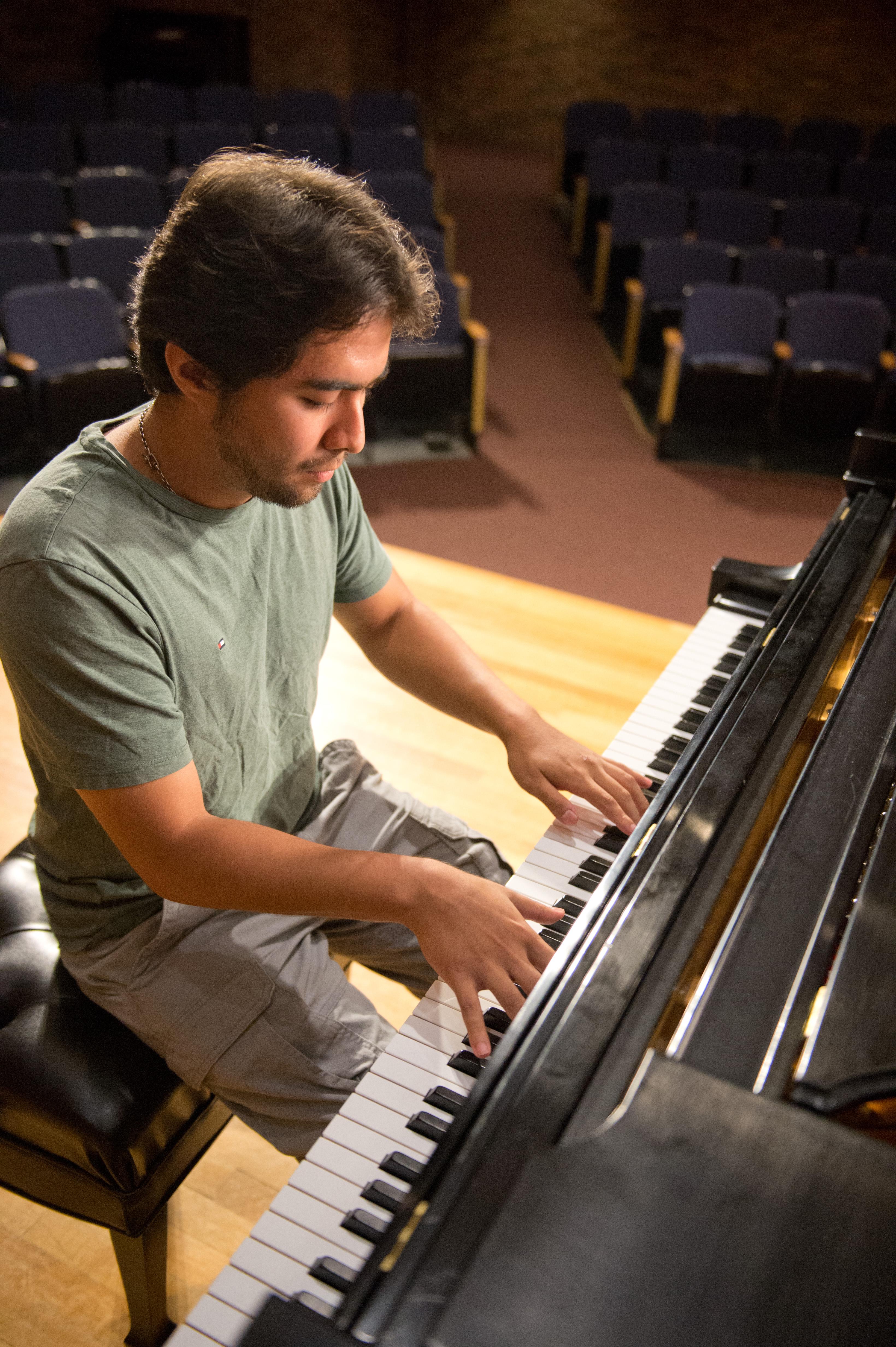 Mount Union student playing the piano on stage.